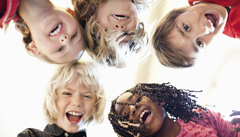 Bild som föreställer fem skrattande skolbarn och som ofta används i marknadsföring av konferensen Skolriksdagen